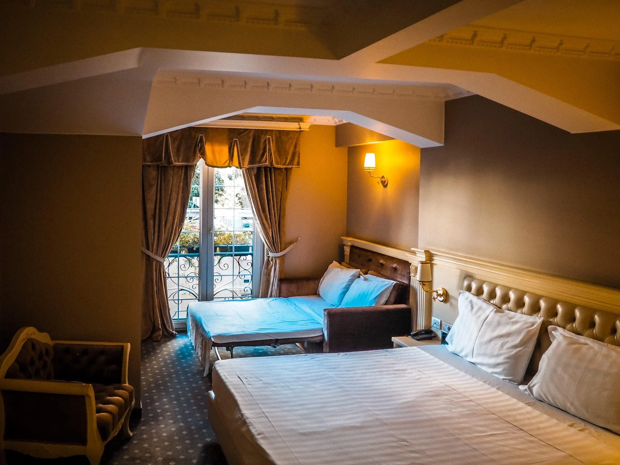 Gastenkamer met tweepersoonsbed, comfortabele inrichting, Frans balkon, elegante gordijnen