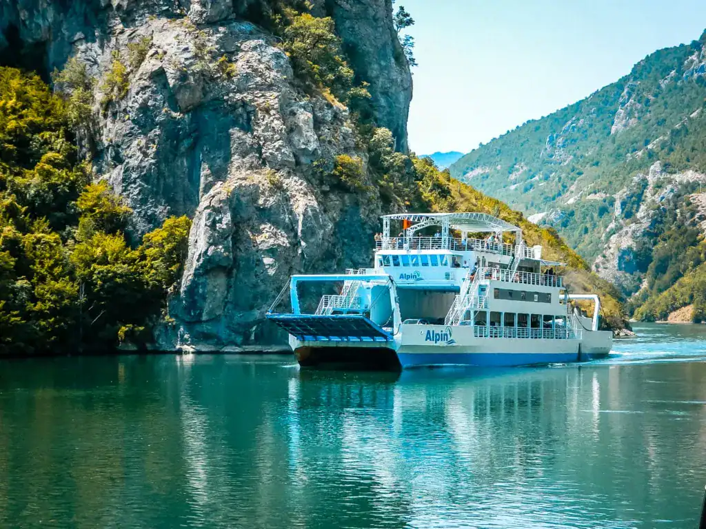 Komani Lake Albania with ferry and mountains in the background