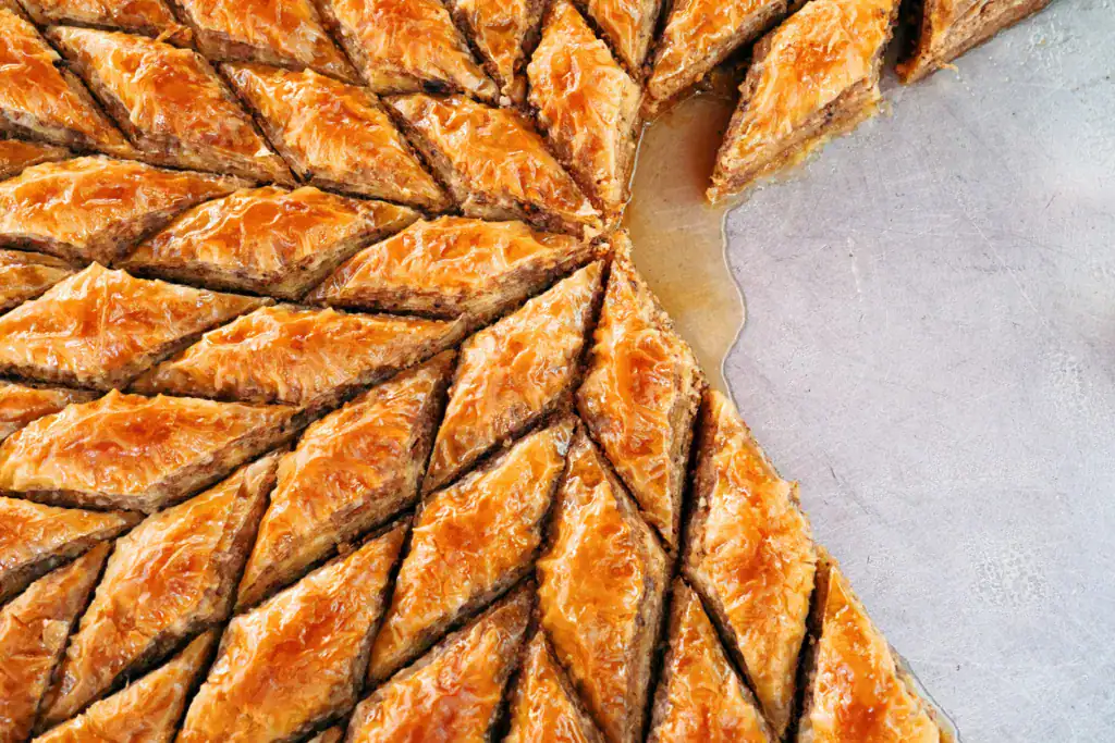 Delicious rhombus shaped village baklava with walnuts in a tray