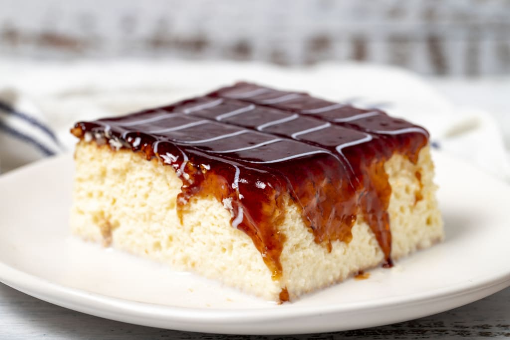 Trilece cake with milk and caramel on a wooden background. patisserie products. Close up