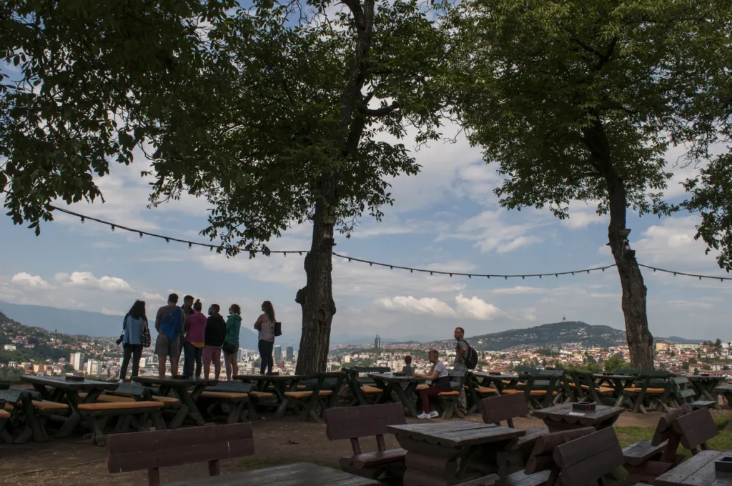 Sarajevo, Bosnia and Herzegovina, Western Balkans - July 8, 2018: people looking at the breathtaking skyline of the capital Sarajevo, surrounded by the Dinaric Alps and situated along the Miljacka River, seen from the top of Zuta Tabija (Yellow Fortress)