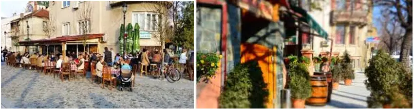 Historische albanische Stadt mit Straßencafé, Tischen und Gästen an einem sonnigen Tag, ideal für Tourismus und Kulturreisen in Albanien.