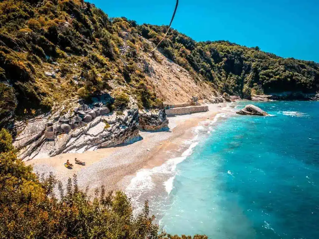 Rondreis Albanië 14 dagen Bergen Zee - Zuid-Albanese kust met strand en turquoise water, omringd door groene kliffen en bergen