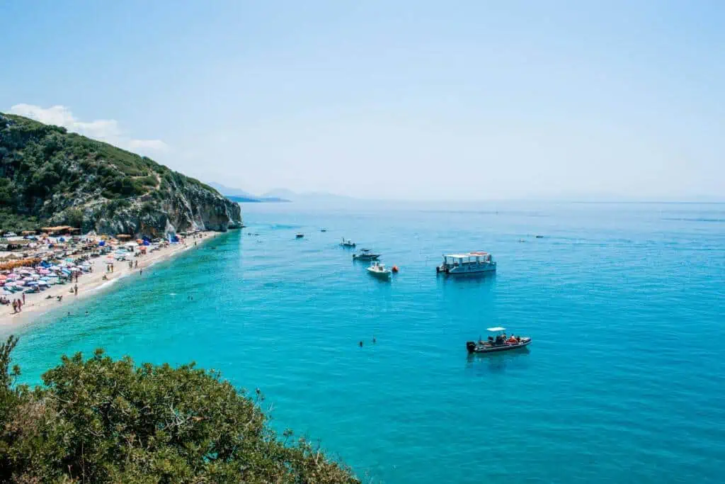 Gjipe Beach Albanien Malerischer Strand an der albanischen Riviera mit klarem Wasser und bunten Sonnenliegen